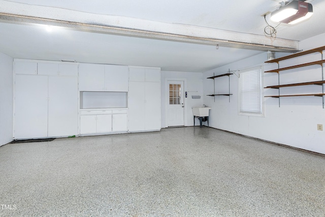 garage featuring a sink and a garage door opener