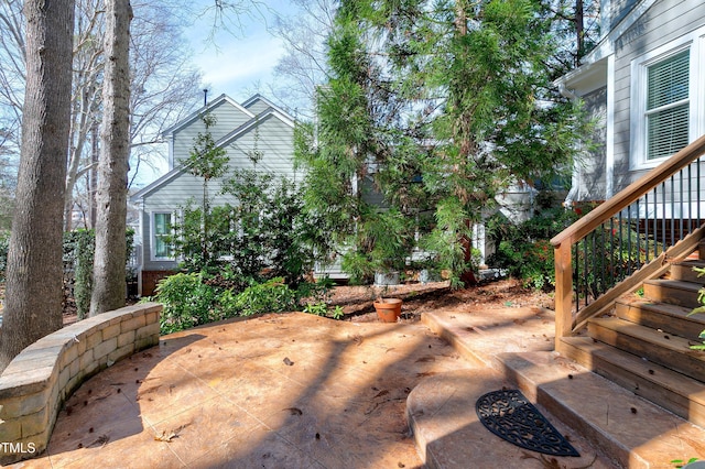 view of yard featuring stairs and a patio