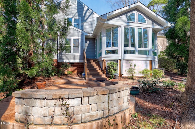 exterior space with a sunroom and stairway