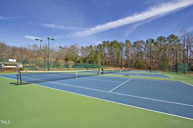 view of tennis court featuring fence