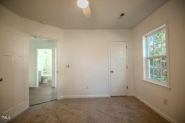 empty room with ceiling fan and carpet floors