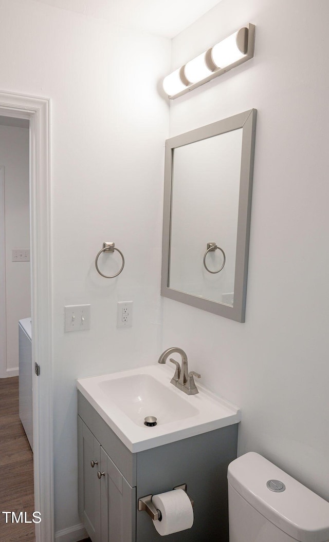 bathroom featuring vanity, toilet, and wood-type flooring