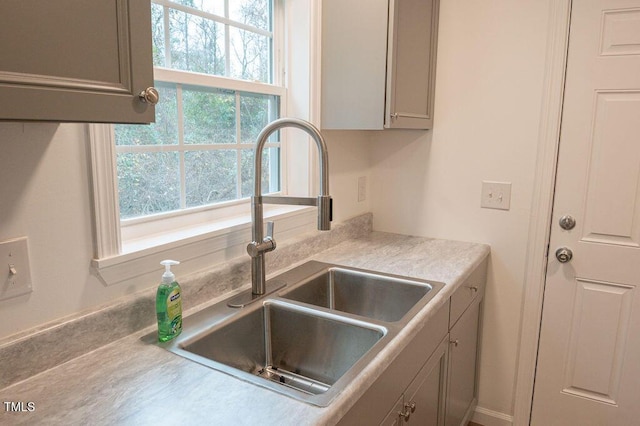 kitchen featuring gray cabinets and sink