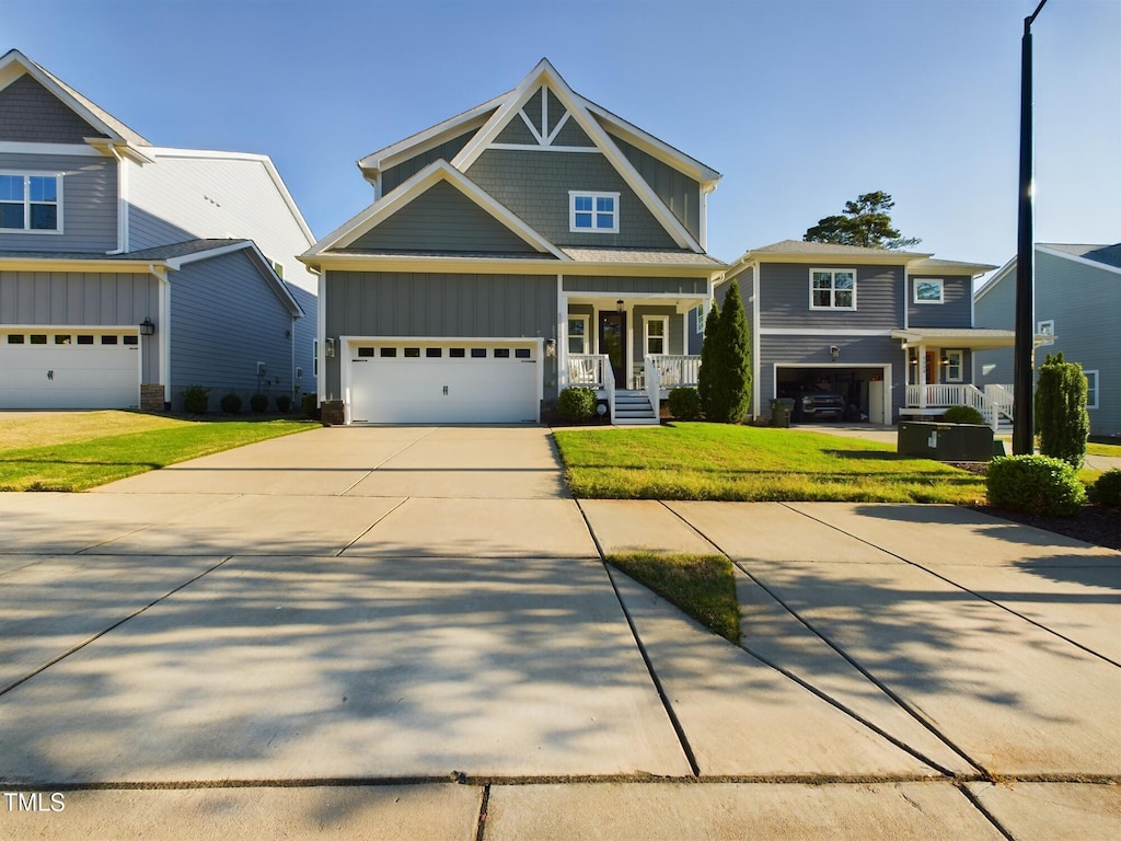 craftsman-style house featuring a garage and a front yard