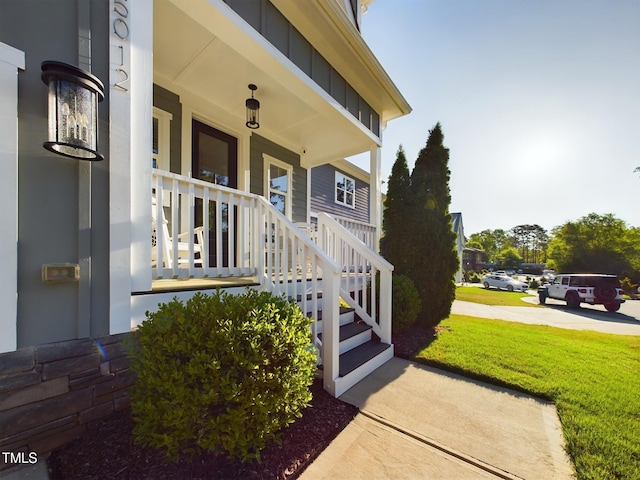 view of exterior entry featuring covered porch