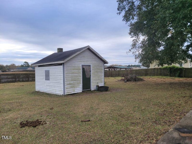 view of outbuilding featuring a yard