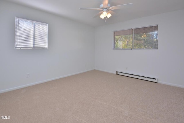 carpeted spare room with ceiling fan and a baseboard heating unit