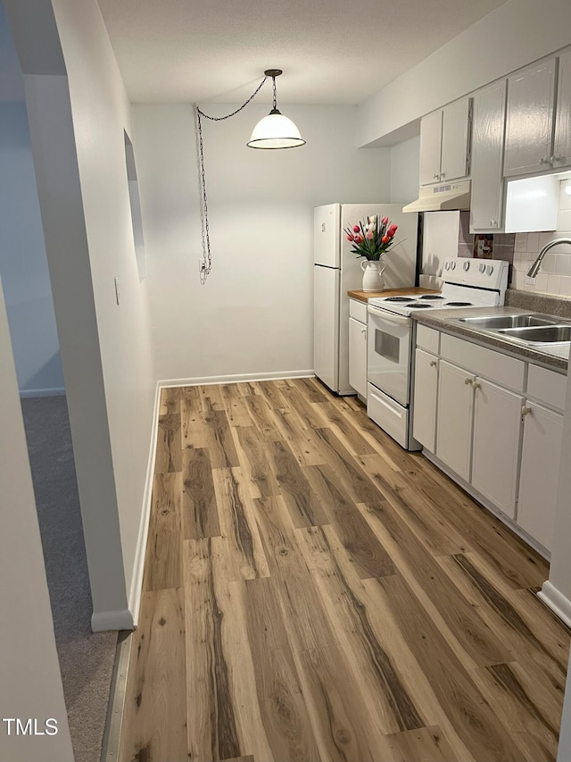 130 S Estes Dr Unit G5, Chapel Hill, NC 27514 - kitchen with white electric range oven, under cabinet range hood, white cabinets, and decorative backsplash