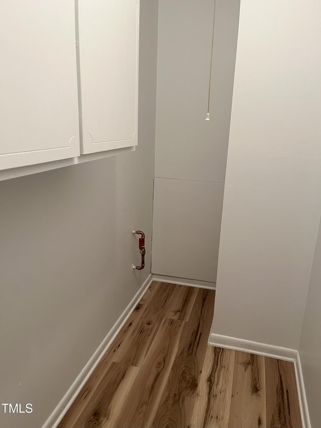 130 S Estes Dr Unit G5, Chapel Hill, NC 27514 - laundry area with wood finished floors and baseboards