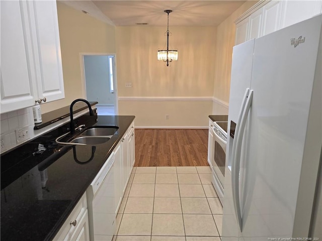 kitchen featuring white cabinetry, sink, light hardwood / wood-style flooring, backsplash, and white appliances