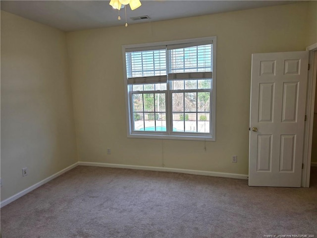 empty room featuring light carpet and ceiling fan