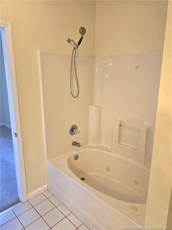 bathroom with tile patterned floors and shower / bathtub combination