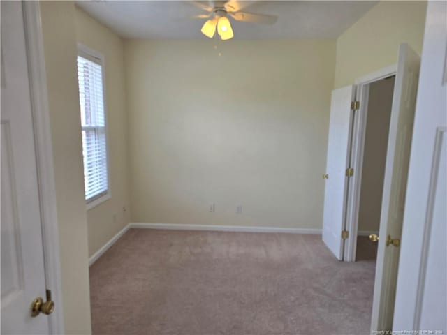 spare room with light carpet and ceiling fan