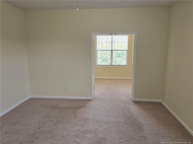 unfurnished room featuring light colored carpet