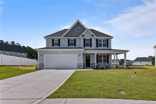 view of front facade featuring covered porch, a garage, and a front yard