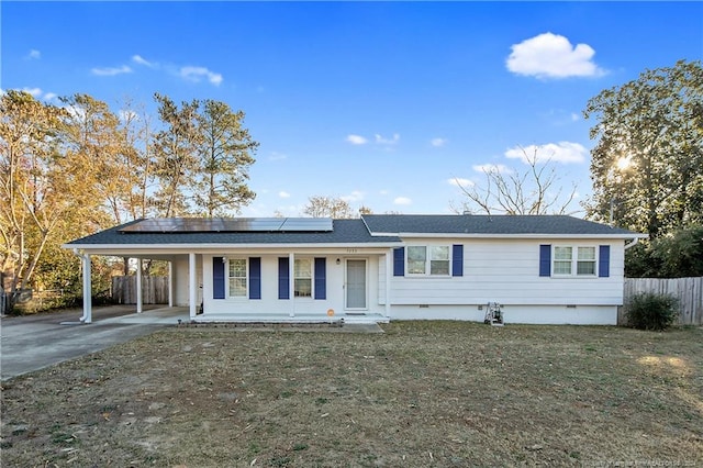 ranch-style home featuring a carport, a porch, and a front lawn