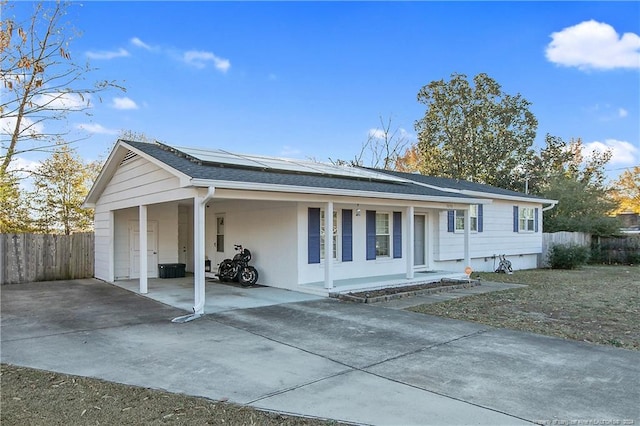 ranch-style home featuring solar panels and a porch