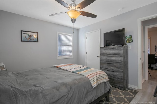 bedroom with ceiling fan and light hardwood / wood-style floors