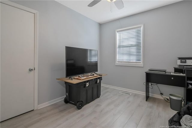 office with light hardwood / wood-style flooring and ceiling fan