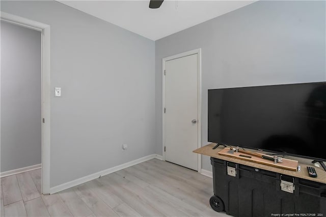 home office with ceiling fan and light hardwood / wood-style flooring