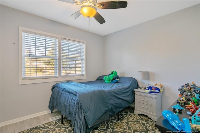 bedroom with hardwood / wood-style flooring and ceiling fan