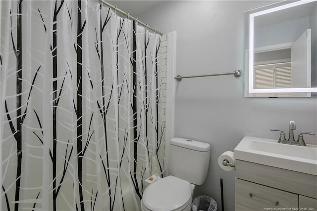 bathroom with a shower with curtain, vanity, and toilet