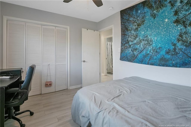 bedroom with a closet, light hardwood / wood-style flooring, and ceiling fan