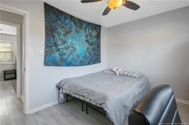 bedroom with ceiling fan and wood-type flooring