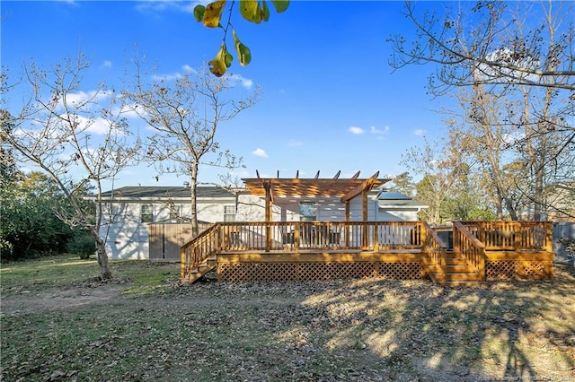 rear view of property featuring a pergola and a wooden deck