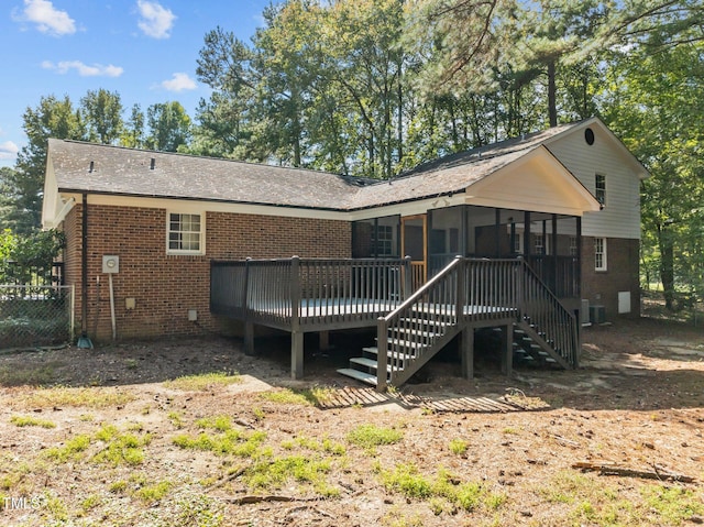 rear view of property with a sunroom, stairway, a wooden deck, central AC, and brick siding