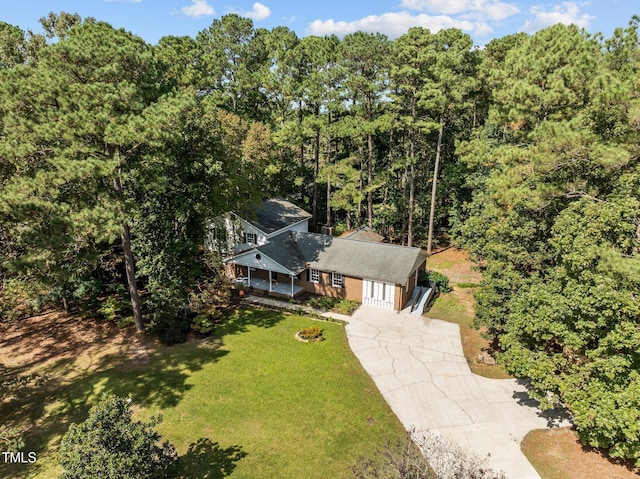 drone / aerial view featuring a forest view