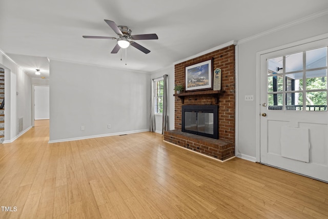 unfurnished living room featuring crown molding, light wood-style floors, visible vents, and a fireplace