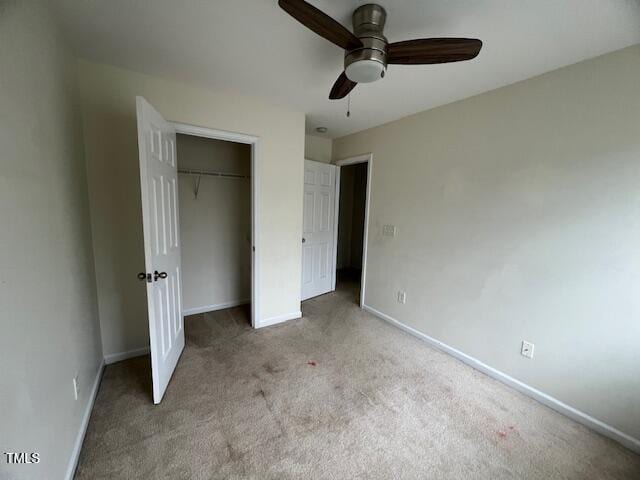 unfurnished bedroom with light carpet, a closet, and ceiling fan