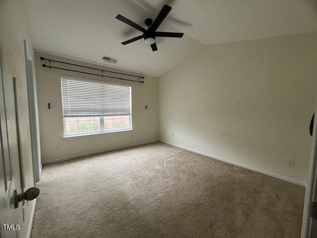 carpeted empty room with ceiling fan and lofted ceiling