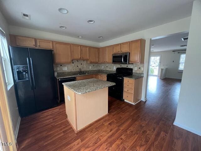 kitchen with a center island, dark hardwood / wood-style floors, tasteful backsplash, and black appliances