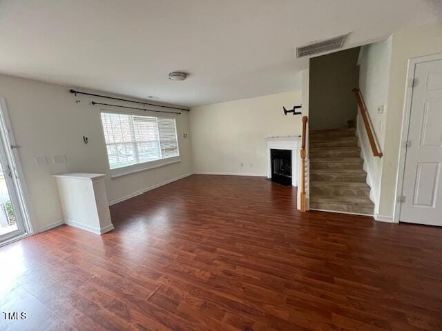 unfurnished living room featuring dark hardwood / wood-style floors