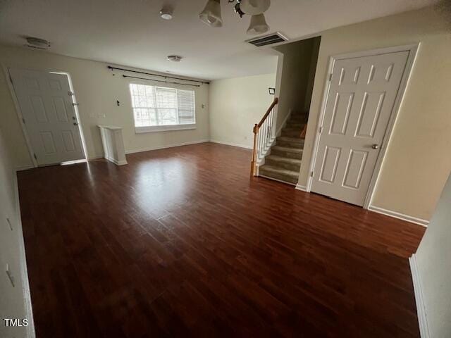 unfurnished living room featuring dark hardwood / wood-style floors