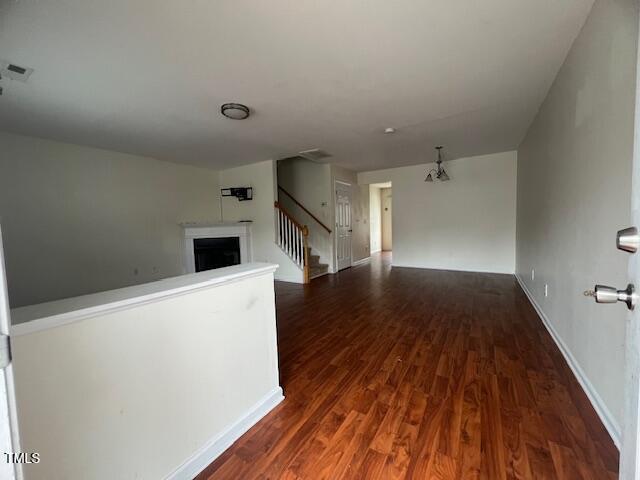 interior space featuring a chandelier and dark hardwood / wood-style flooring