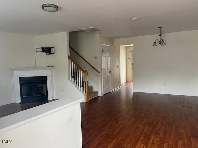 unfurnished living room featuring dark hardwood / wood-style flooring