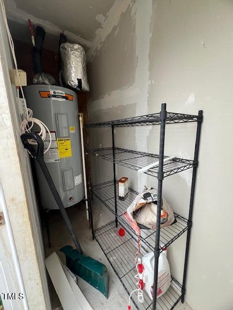 utility room featuring water heater