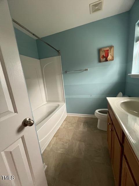 full bathroom featuring shower / tub combination, vanity, and toilet