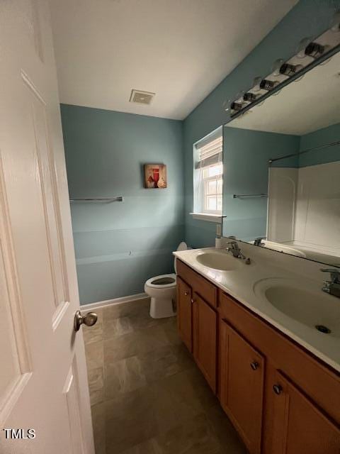 bathroom featuring vanity and toilet