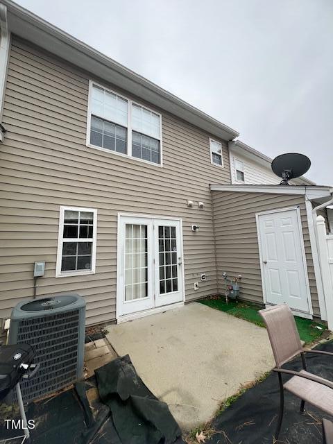 rear view of property with a patio area and cooling unit