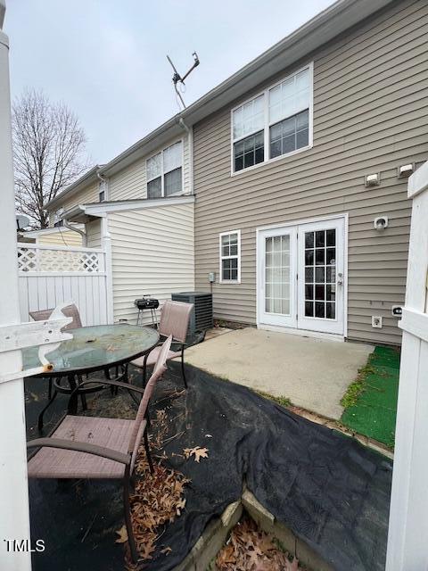 rear view of property with french doors, central AC unit, and a patio area