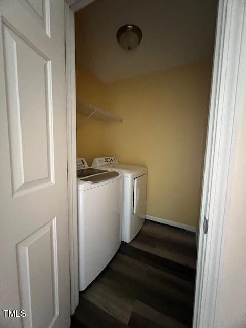 washroom featuring dark wood-type flooring and washing machine and clothes dryer