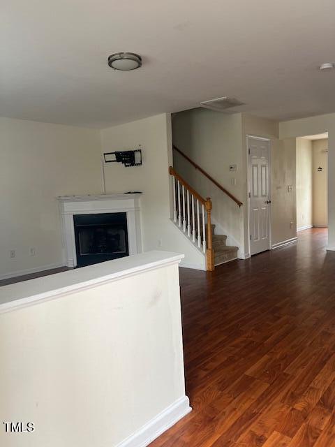 unfurnished living room featuring dark hardwood / wood-style flooring