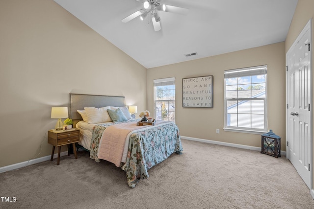 bedroom featuring multiple windows, ceiling fan, light colored carpet, and lofted ceiling