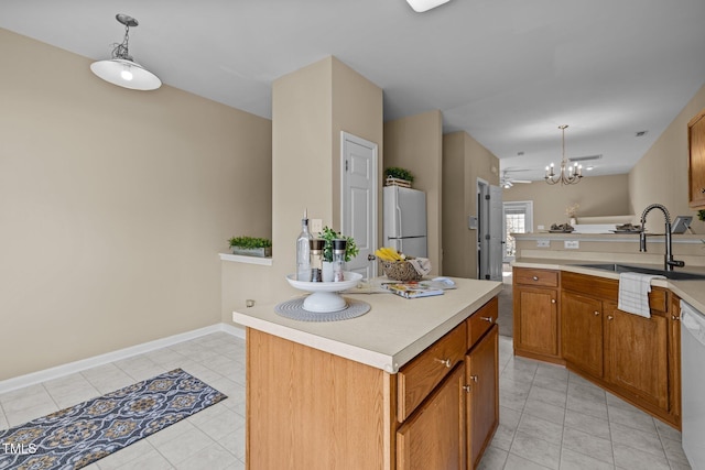 kitchen featuring a notable chandelier, decorative light fixtures, a center island, and white appliances