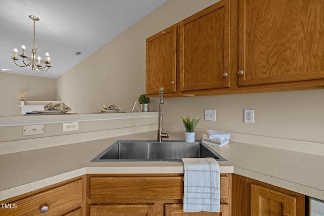 kitchen with decorative light fixtures, a notable chandelier, and sink