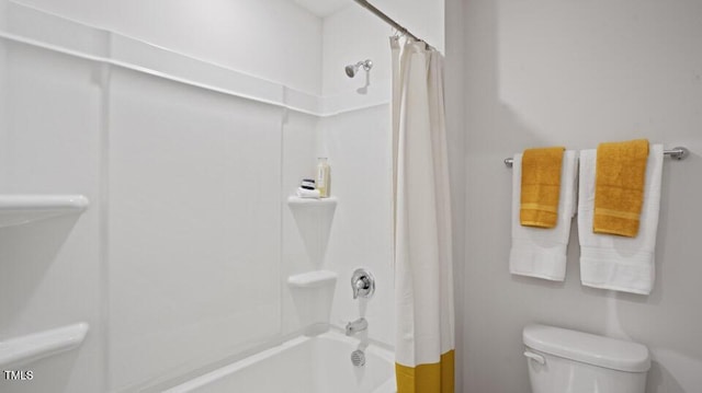 bathroom with toilet and shower / tub combo